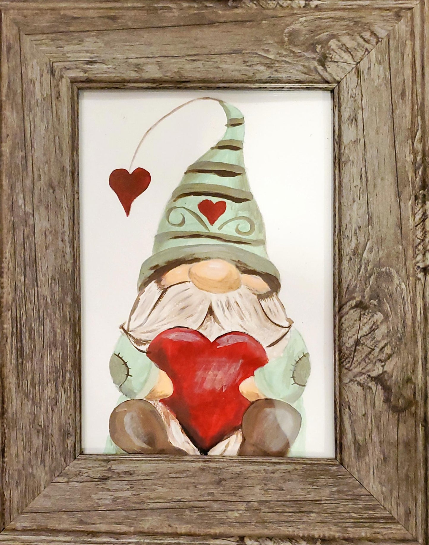 a valentine's gnome holding a heart for an amazing paint n sip night