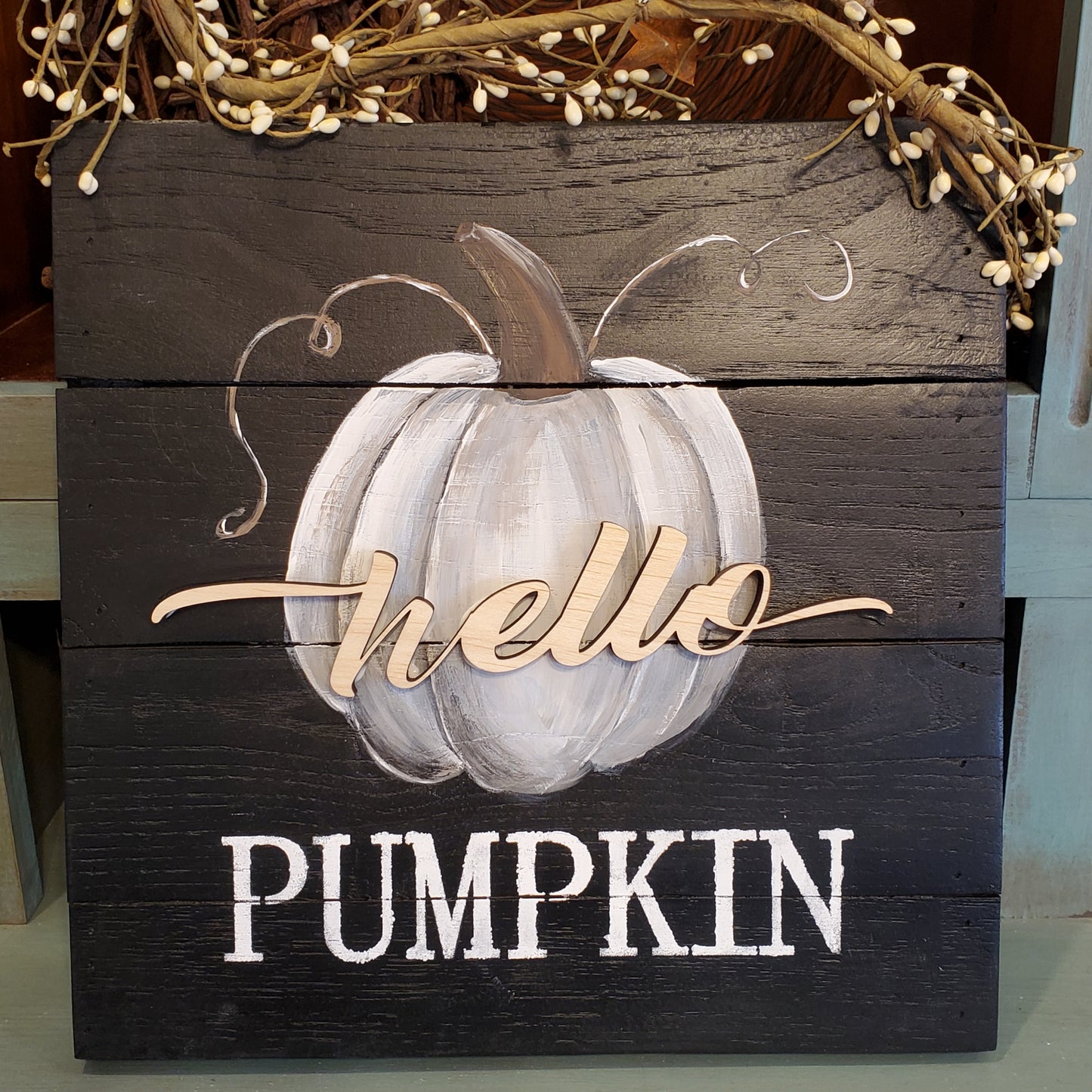 black pallet wood sign with painted gray and blue pumpkin. Laser cut "hello" and stenciled "pumpkin"