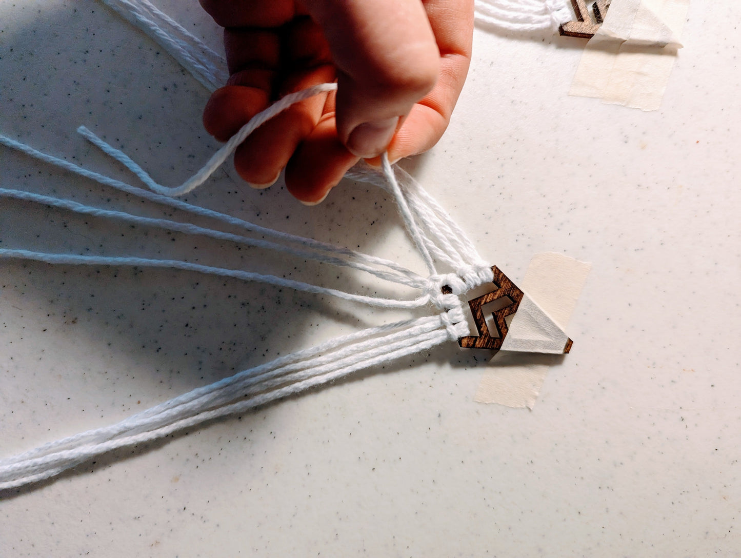 Handmade laser cut wood macrame earrings in process