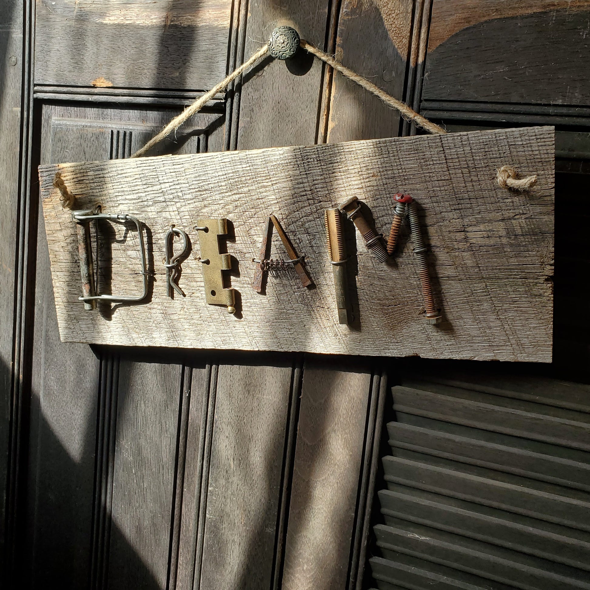 "DREAM" junk sign. Found metal objects on reclaimed barn wood. 6" x 15"