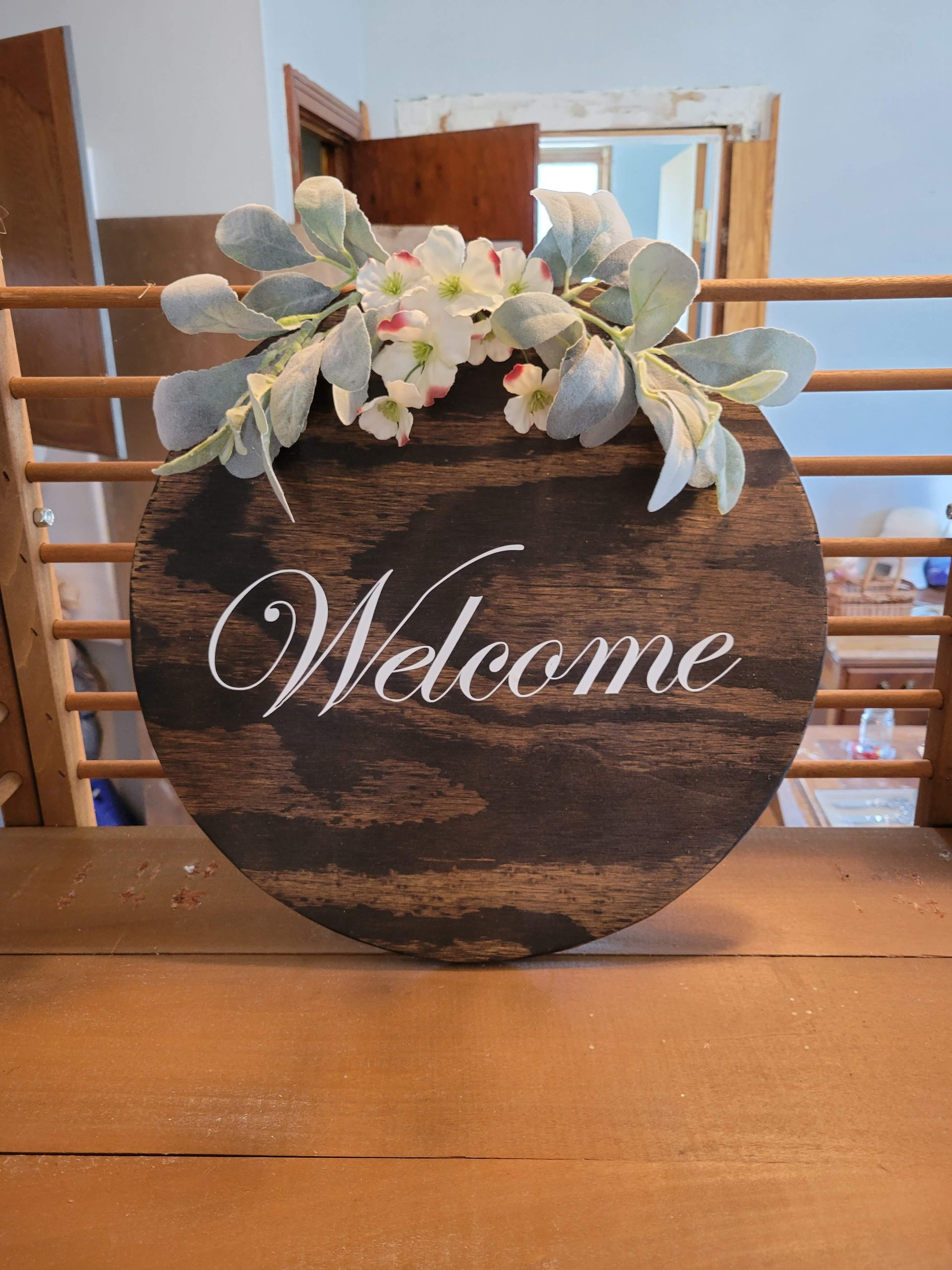 Round welcome sign with lambs ear and white flowers, stained with white letters