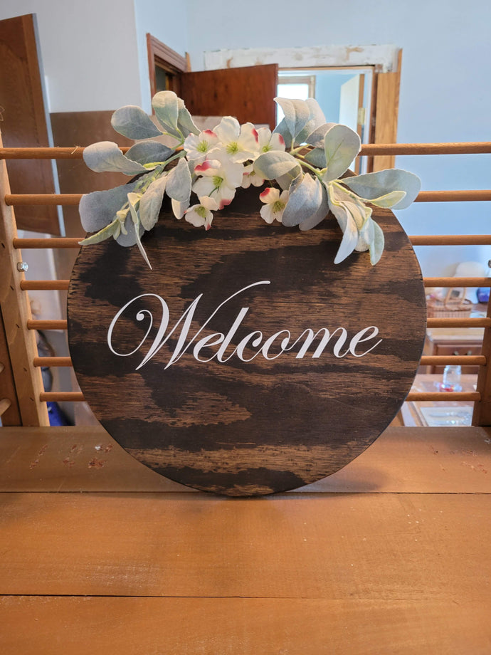 Round welcome sign with lambs ear and white flowers, stained with white letters