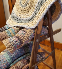 Load image into Gallery viewer, Learn how to make your own rag rug! Please bring at least one bed sheet from a thrift store, or your own linen closet. We will be providing the rest of the sheets and crochet hooks. You may not complete the entire rug in this workshop but you will probably get about halfway, depending on your crochet speed. But you should have enough of an understanding of the pattern that you will be able to finish this rug, and make more!
