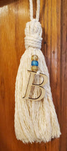 Load image into Gallery viewer, Design your own tassel with blue and gold beads and laser cut letters.
