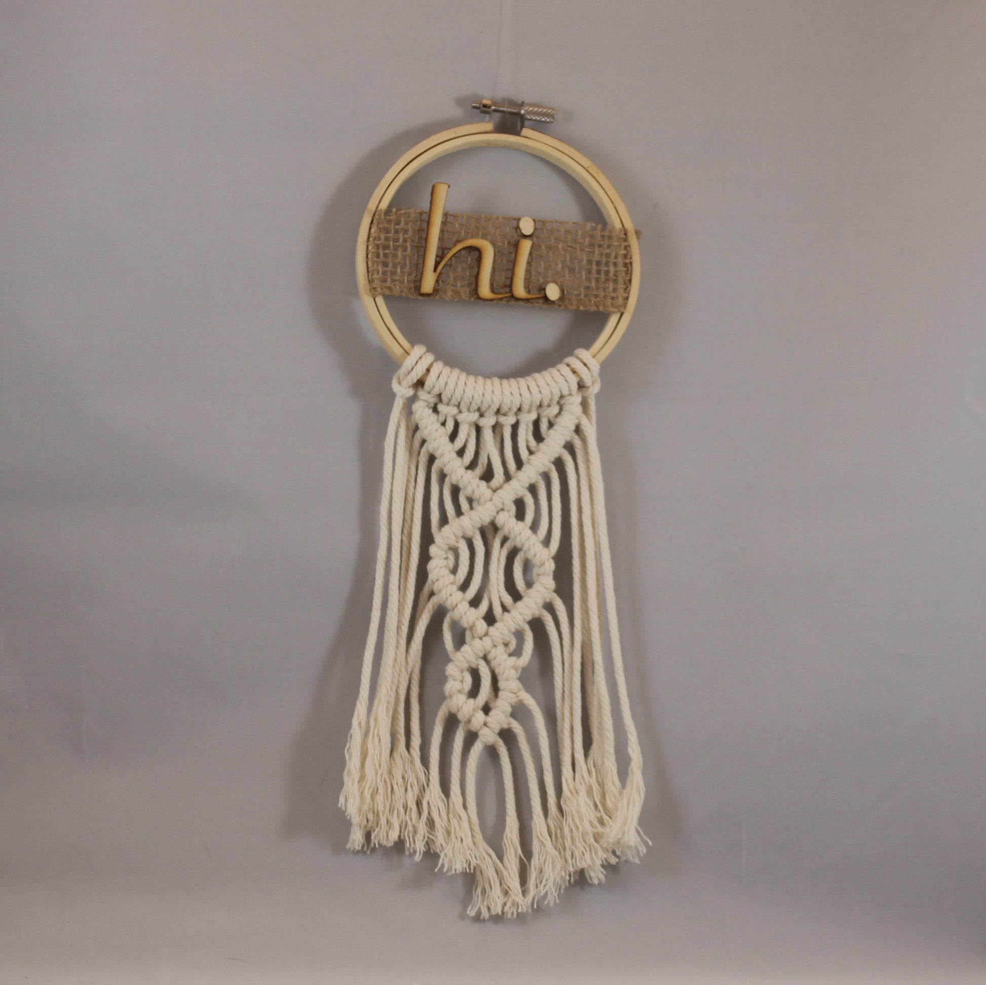 This adorable little 4" hoop greets you with a joyful "hi." white macramé, wooden letters, burlap ribbon