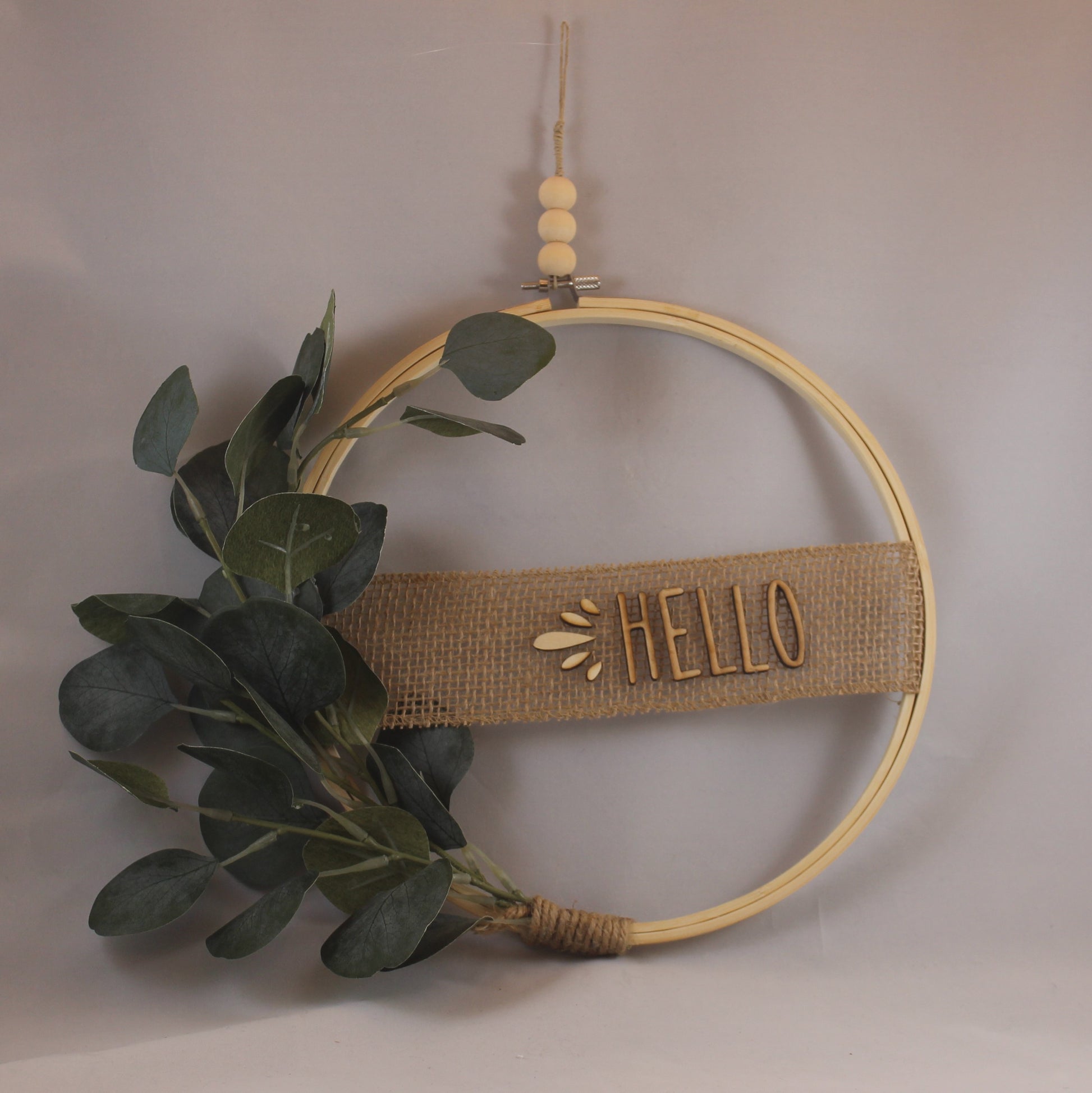 This charming, neutral wreath will brighten up any space in your home! 10.5" wide, wooden beads and letters, eucalyptus leaves, burlap ribbon