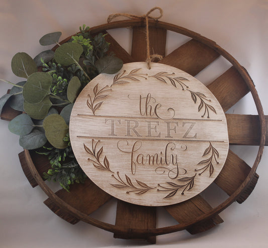 Laser engraved wood sign customized with your family name! Olive branch wreath. Script and serif fonts. option of multiple thicknesses of wood: Thin = 1/8" and Thick = 1/2". dry brushed with white paint. jute rope hanger. basket and greenery not included.