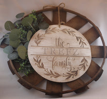 Load image into Gallery viewer, Laser engraved wood sign customized with your family name! Olive branch wreath. Script and serif fonts. option of multiple thicknesses of wood: Thin = 1/8&quot; and Thick = 1/2&quot;. dry brushed with white paint. jute rope hanger. basket and greenery not included.
