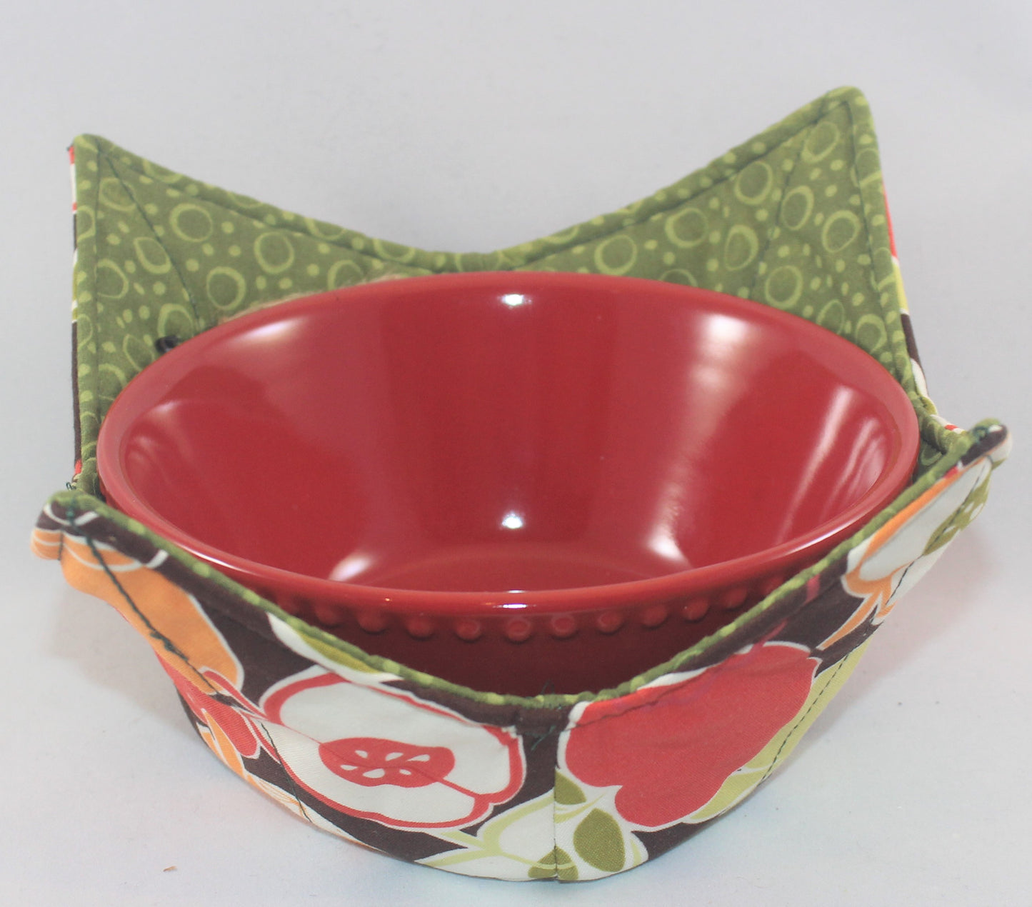 Variety of colors and patterns, these handmade bowl sleeves will protect your hands from the heat while also adding a pretty pop of color to your kitchen. Bowl included! Each sleeve is unique. Choose between a red or blue bowl.