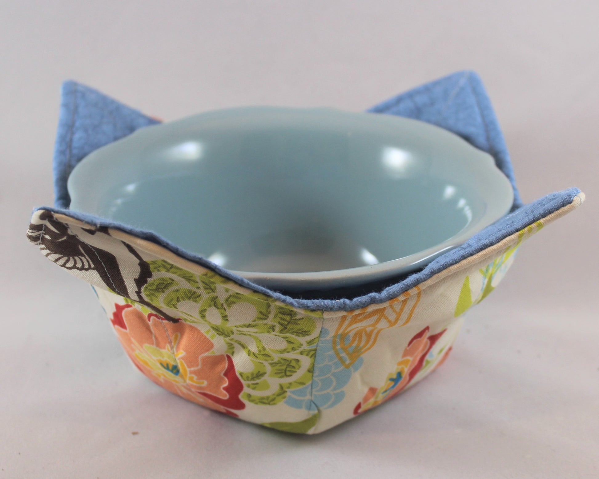 Variety of colors and patterns, these handmade bowl sleeves will protect your hands from the heat while also adding a pretty pop of color to your kitchen. Bowl included! Each sleeve is unique. Choose between a red or blue bowl.