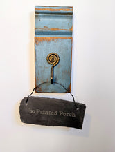 Load image into Gallery viewer, This gorgeous plinth was recovered from an old farm house. It has been painted blue and sanded. The interesting hammered metal spiral hook adds another dimension to this wall decor. 
