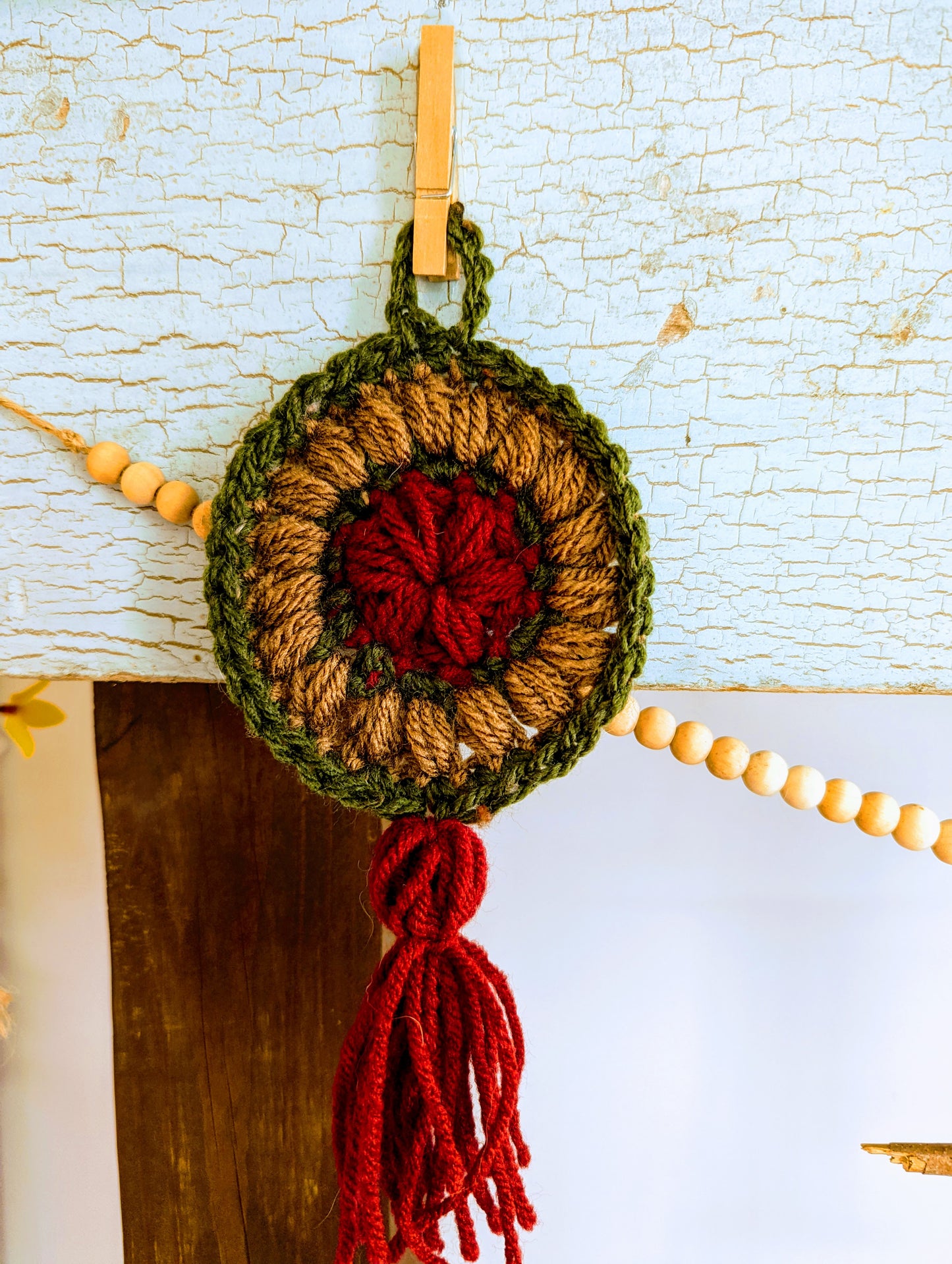 red brown and green round puff stitch crochet dream catcher with tassel