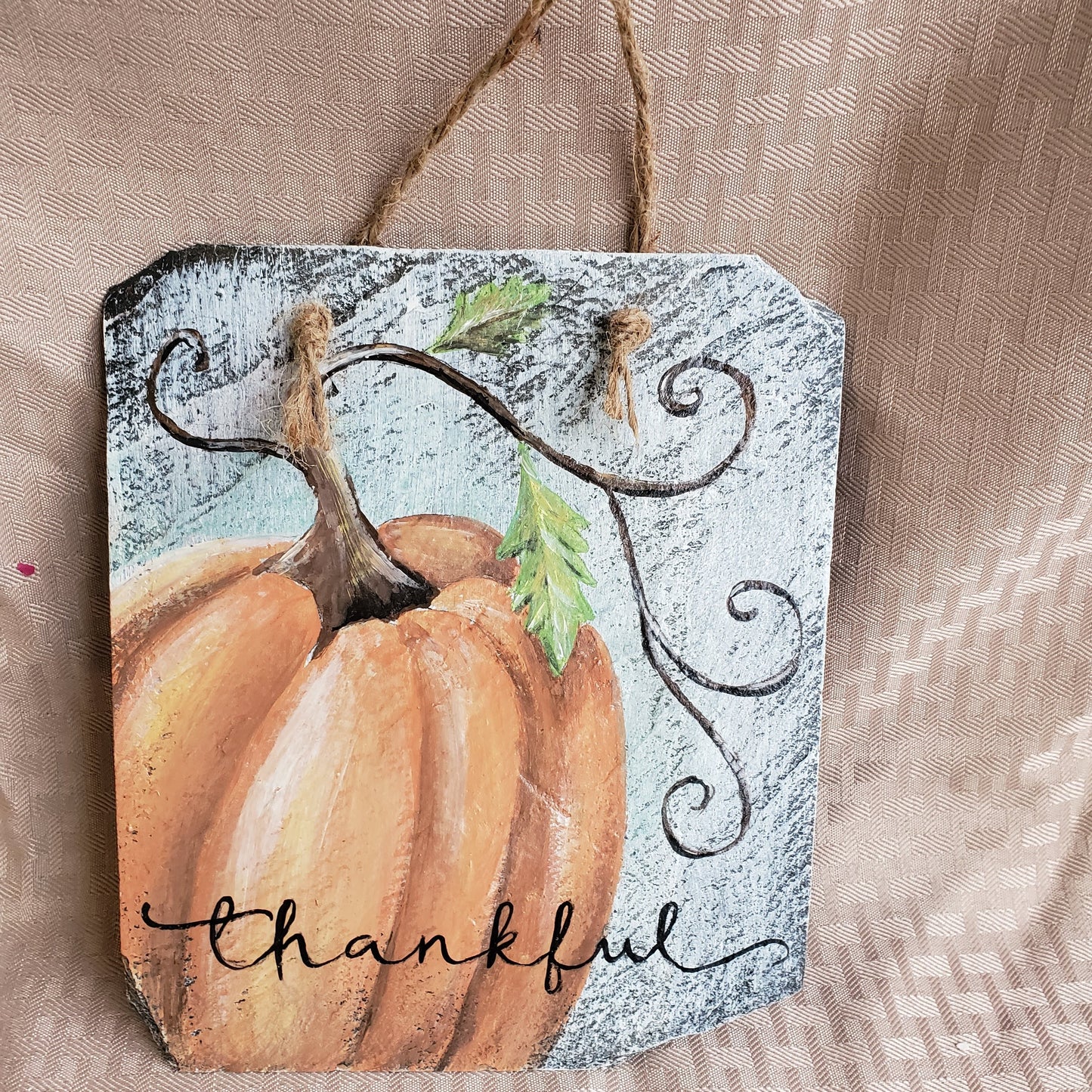 This charming slate sign is whitewashed and hand-painted. A soft orange pumpkin and handwritten "thankful" will look beautiful in your family room. precious small size 7" x 8" jute rope hanger