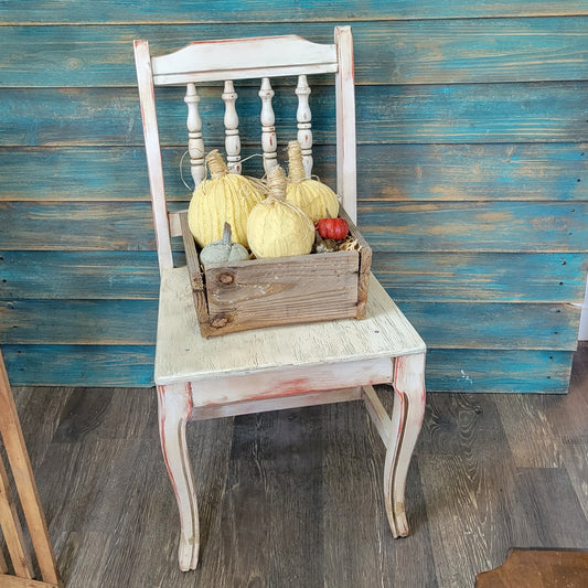 This small antique white chair has been upcycled into a plant stand chair. A plant stand chair has a flat plywood seat to hold potted plants, or any seasonal décor, on your front porch or anywhere on your property that you keep potted plants. 