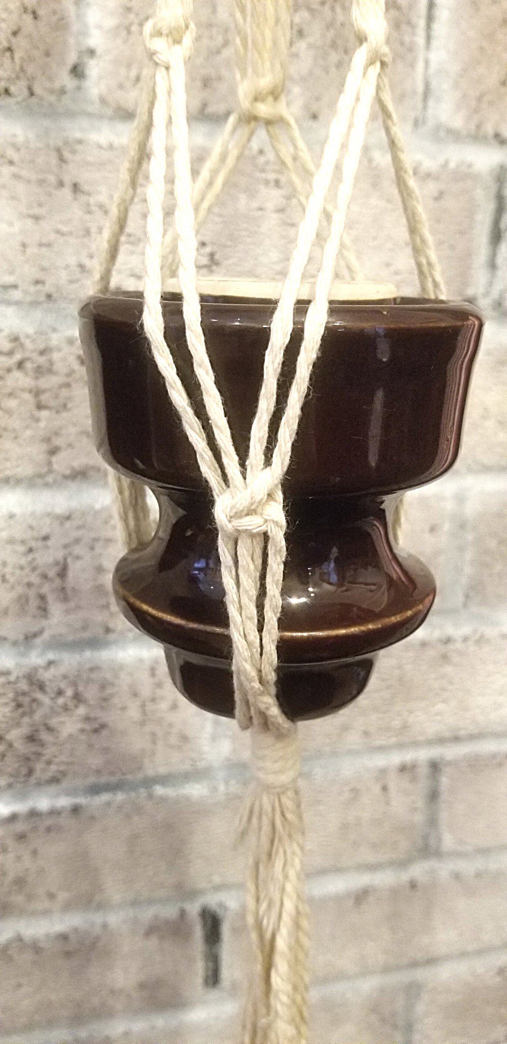 Macramé hanger with brown antique ceramic insulator.