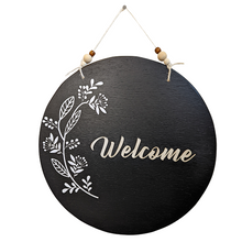 Load image into Gallery viewer, This black wooden Welcome sign has bohemian vibes with the three dimensional paper flower detail and multi-colored wooden beads. The &quot;Welcome&quot; is laser cut wood.
