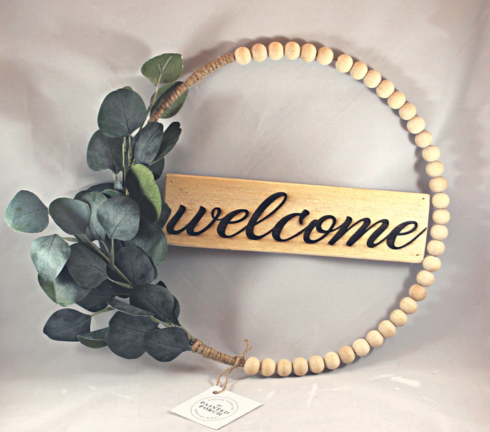 Beautiful raw wood beaded hoop wreath with eucalyptus. Laser engraved wood sign says 